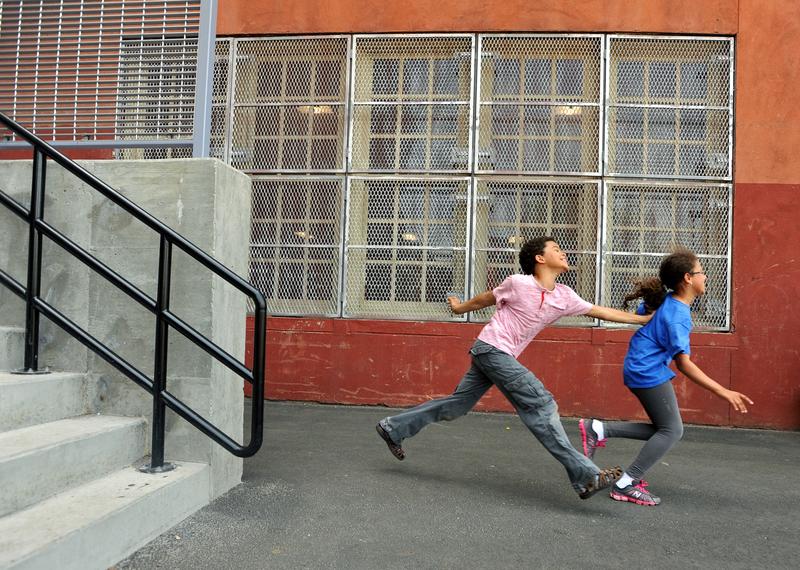Third grader Q Daily tags classmate Valery Serrano at recess at The Brooklyn New School.