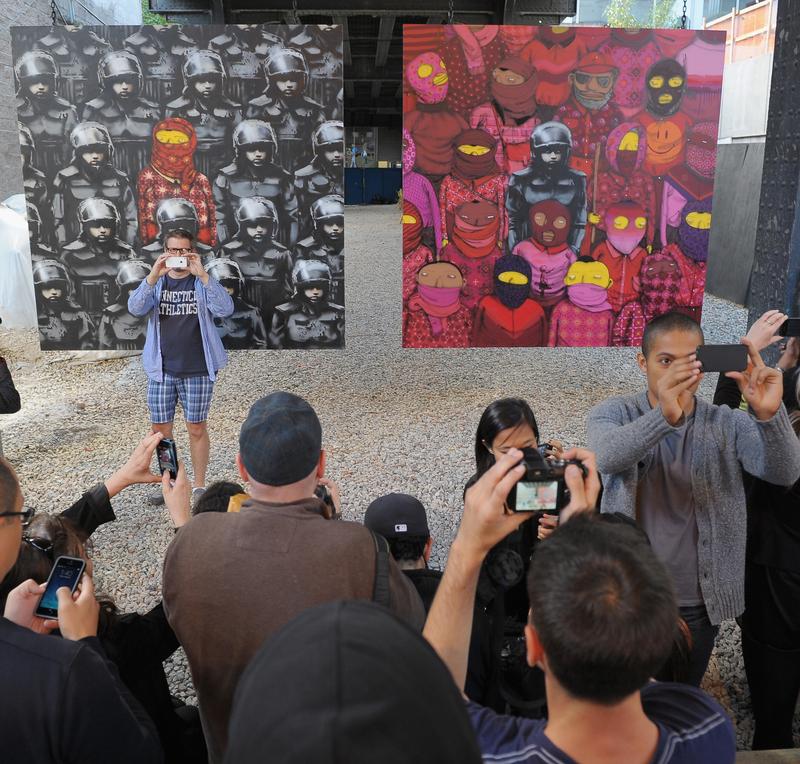 A crowd gathers to view Banksy's latest work on October 18, 2013 in New York City