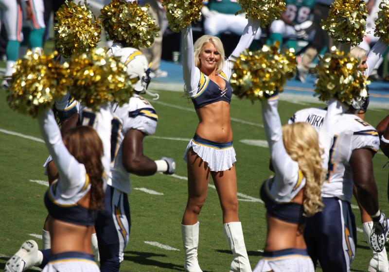 San Diego Chargers player running through the Chargers Cheerleaders