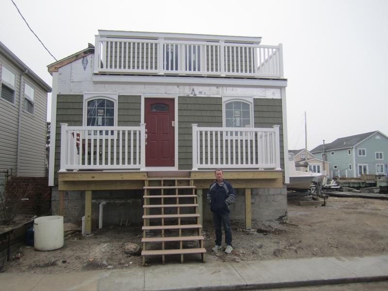 Dan Mundy, president of the Broad Channel Civic Association, in front of house that has been elevated, but not enough to satisfy FEMA's advisory flood maps.