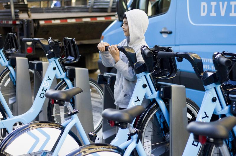 Seven-year-old Maurice Neuman checks out one of the new bikes in Chicago's bike sharing program, Divvy.