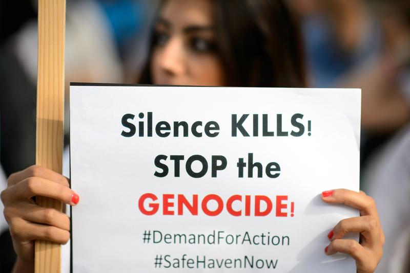 A demonstrator holds a placard while protesting against the actions of the Islamic State in Iraq outside Downing Street in central London.