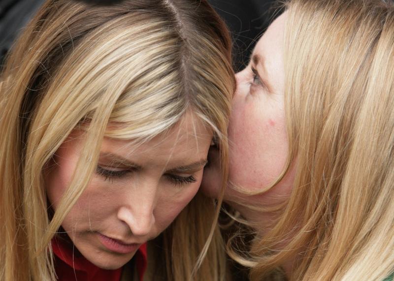 Heather Mills bends down to listen to her sister Fiona as she gives a statement outside the High Court on March 17, 2008 in London, England.