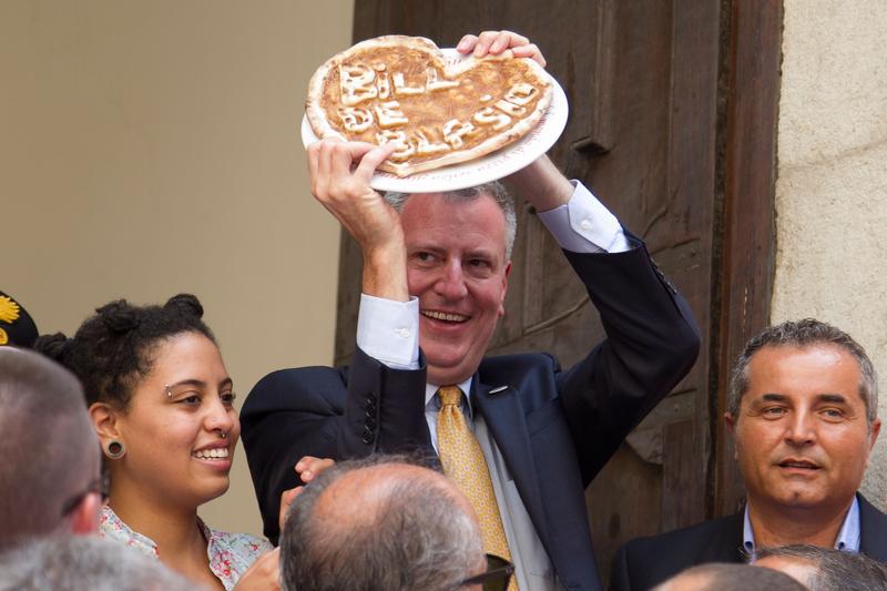 New York City mayor Bill De Blasio and his family holds a pizza with his name on it as he visits the town, Sant'Agata de' Goti, Italy, his grandfather Giovanni de Blasio was born in.