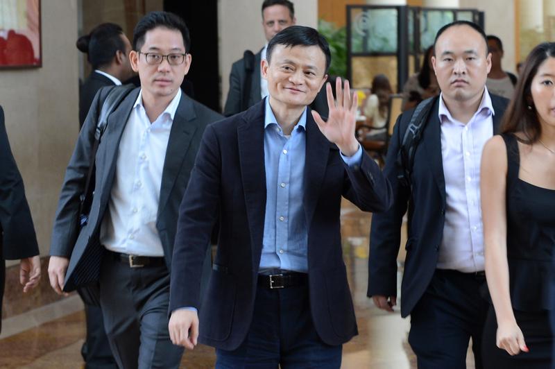 Alibaba founder Jack Ma waves as he leaves a hotel in Singapore on September 16, 2014 in advance of the company's upcoming IPO.