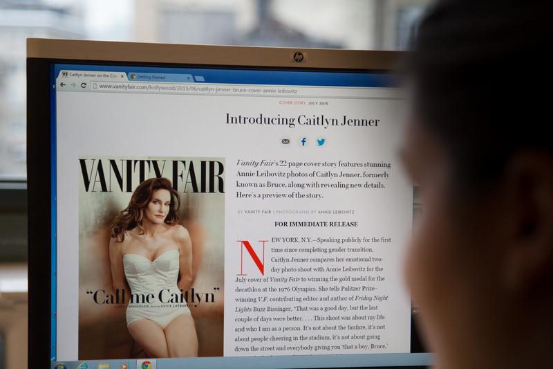 A journalist looks at the 'Vanity Fair' website, where Caitlyn Jenner made her debut.