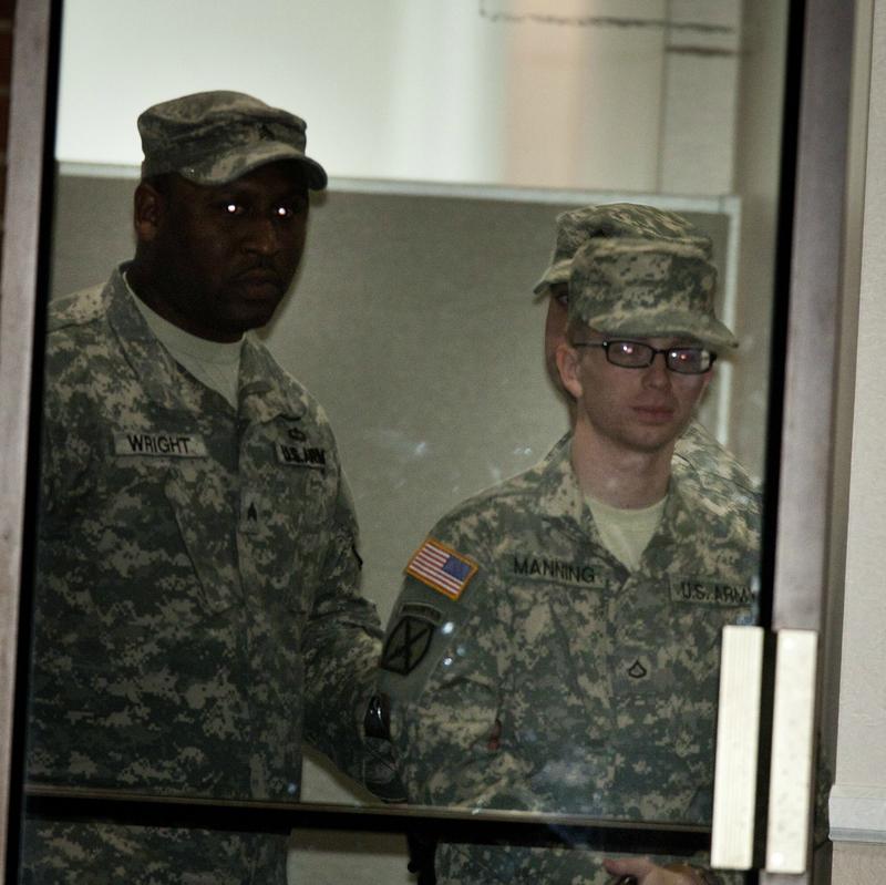 Bradley Manning escorted from the court room after a hearing at Fort Meade