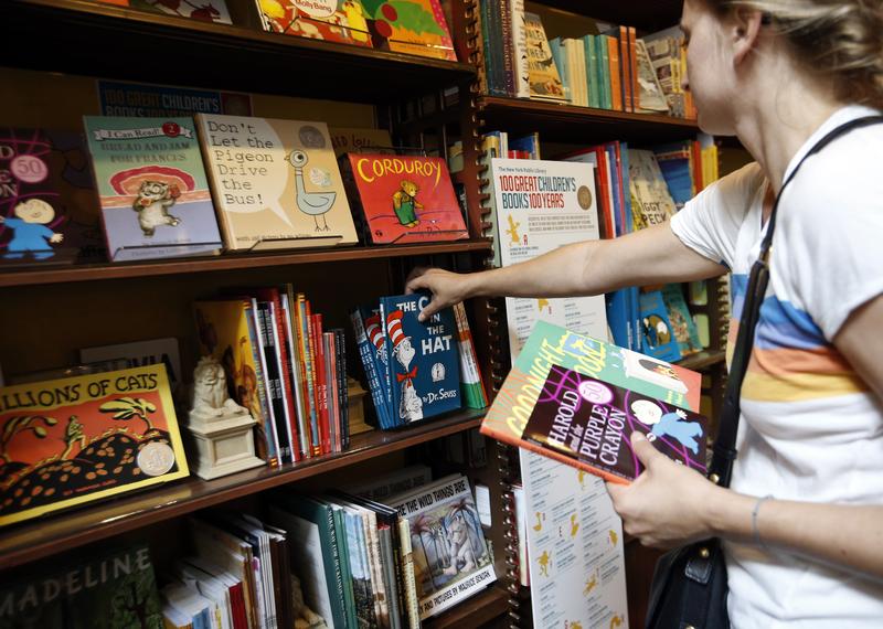 Anne Sophie Parigot searches for books for her 3 and 6-year-old children at the New York Public Library bookstore, Monday, Sept. 30, 2013.