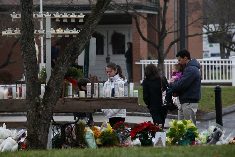 Families visit St. Rose church in Newtown, Conn., for Sunday mass, just two days after a deadly shooting at nearby Sandyhook Elementary School.