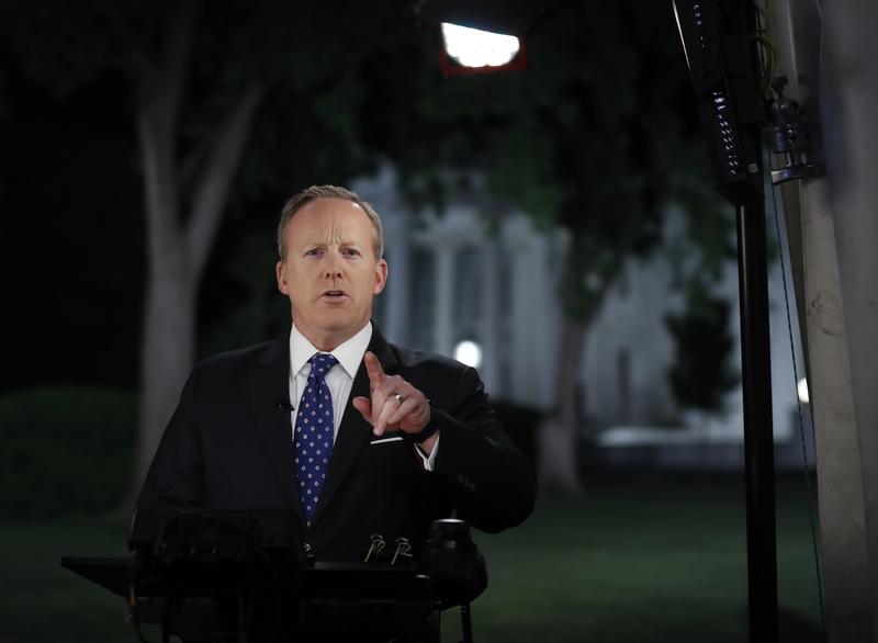 White House press secretary Sean Spicer talks to media in front of the White House after President Trump fired FBI Director James Comey.