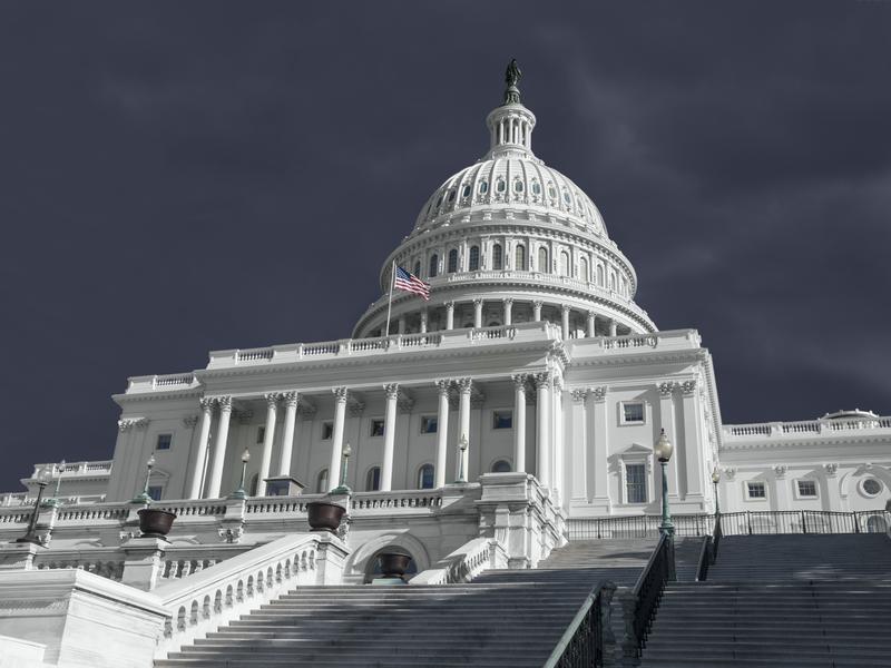 United States Capitol building with stormy weather.