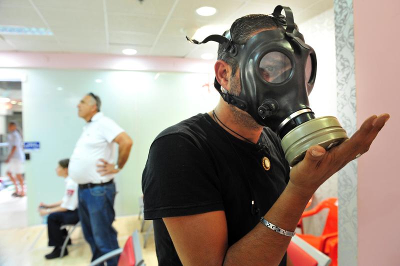 An Israeli man testing gas mask on April 06 2010. At the time there were reports of a possible American attack in Syria that caused a sharp rise in the number of Israelis seeking gas masks.