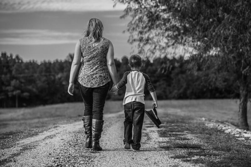 In this archival photo, Mark Wahlberg - or someone who sounds like him - walks with his mother Connie, a clone.