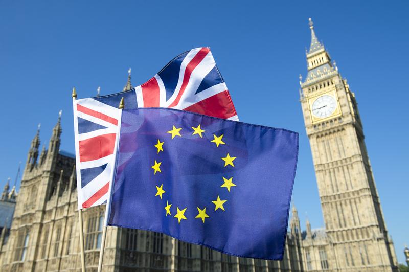 European Union and British Union flag flying in front of Big Ben and the Houses of Parliament at Westminster Palace, London.