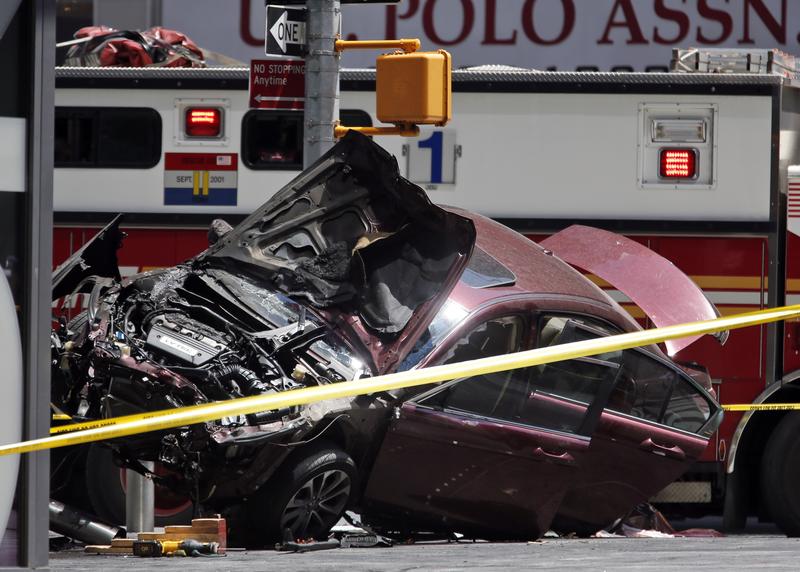 A smashed car sits on the corner of Broadway and 45th Street in New York's Times Square after ploughing through a crowd of pedestrians at lunchtime on Thursday, May 18, 2017.