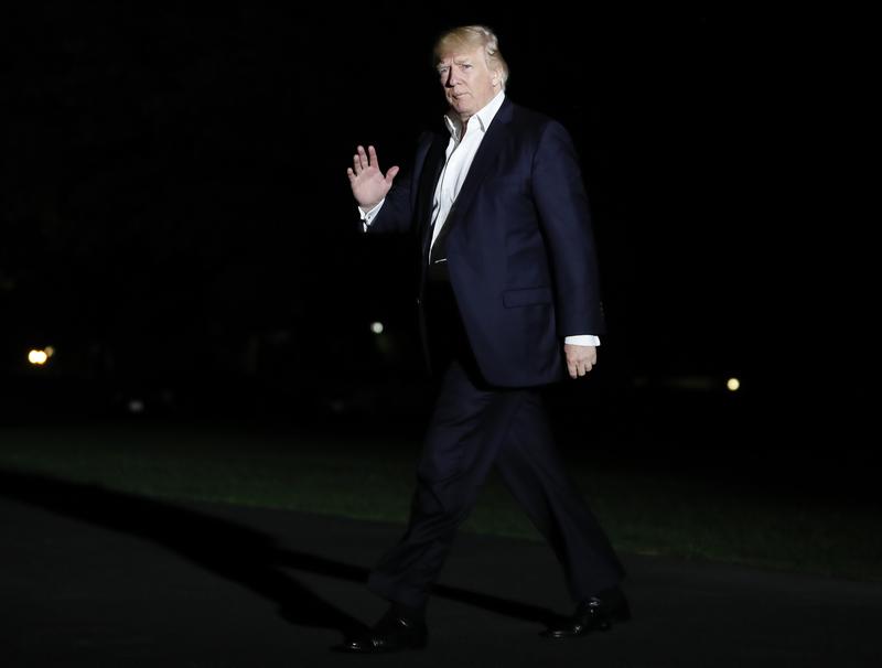 President Donald Trump walks from Marine One across the South Lawn to the White House in Washington, Sunday, May 7, 2017, as he returns from Trump National Golf Club in Bedminster, N.J.