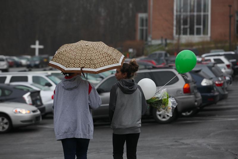 Families visit St. Rose church in Newtown, Conn., for Sunday mass, just two days after a deadly shooting at nearby Sandyhook Elementary School.
