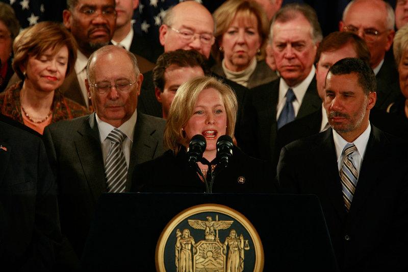 Kirsten Gillibrand (C) speaks as New York Gov. David A. Paterson (R) and former Sen. Al D'Amato look as she is annoucned to be Paterson's choice to fill NY's vacant Senate seat in Jan. 2009.