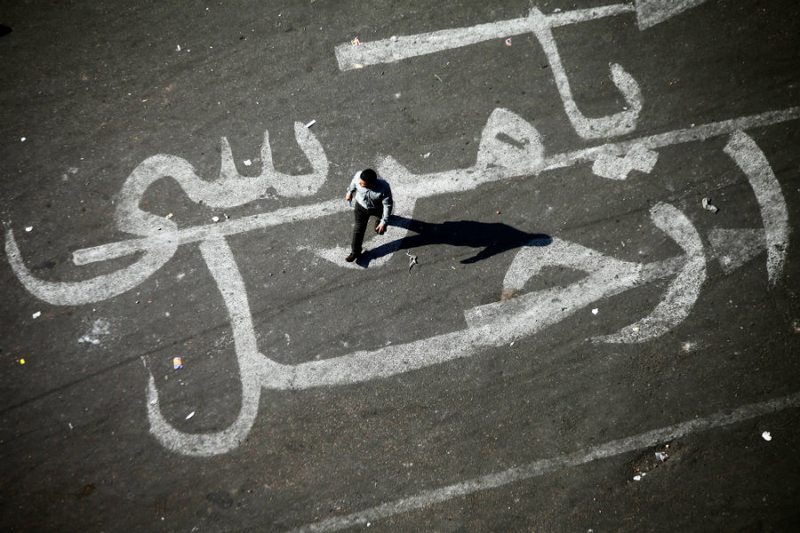 An Egyptian man walks over a graffiti reading 'Morsi Go' on November 25, 2012 at Egypt's landmark Tahrir square in Cairo.