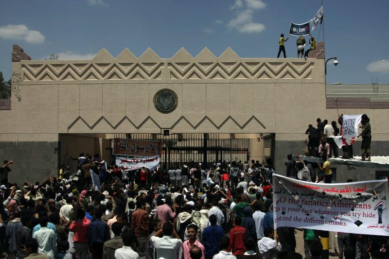 Yemeni protesters try to break through the gate of the US embassy in Sanaa during a protest over a film mocking Islam.
