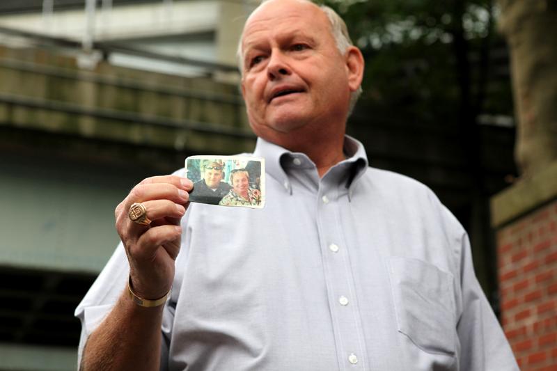Kenneth Fairben shows a picture of his son Keith, who was killed on 9/11. Kenneth is watching the 9/11 Guantanamo Trials at Fort Hamilton in Dyker Heights, Brooklyn.