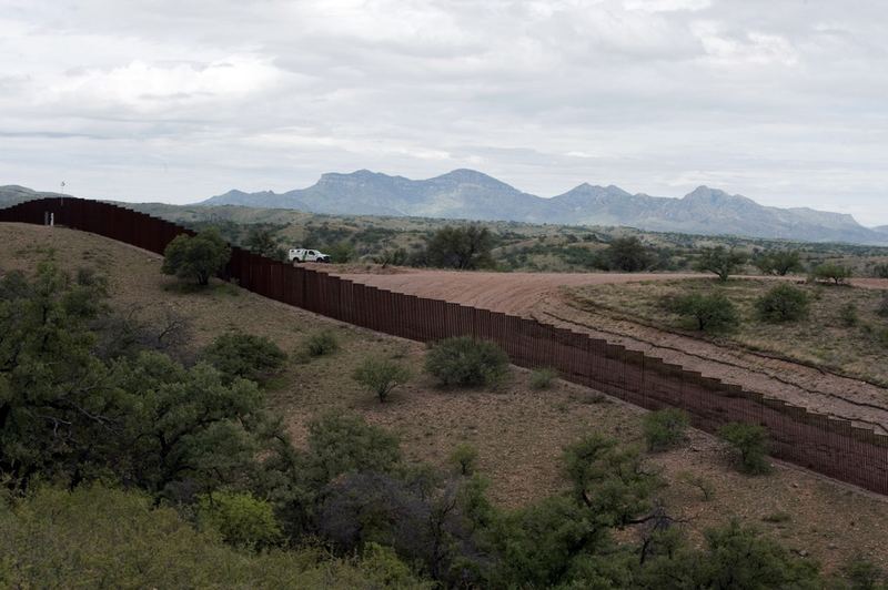 A US Border Patrol vehicle drives along the fence separating the US from Mexico, near the town of Nogales, Sonora, Mexico, on July 31, 2010.