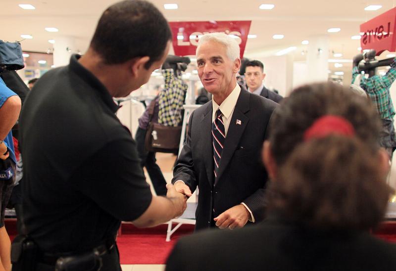 Florida Governor Charlie Crist is greeted while attending a Back to School Sales-Tax Holiday launch event at a Macy's department store August 12, 2010 in Miami, Florida.