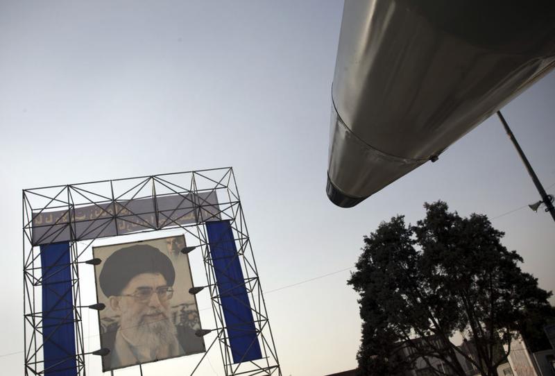 A display long-range surface-to-surface Shahab-3 missile is pictured in front of a portrait of Iran's supreme leader, Ayatollah Ali Khamenei, in southern Tehran on Sept. 23. 2010