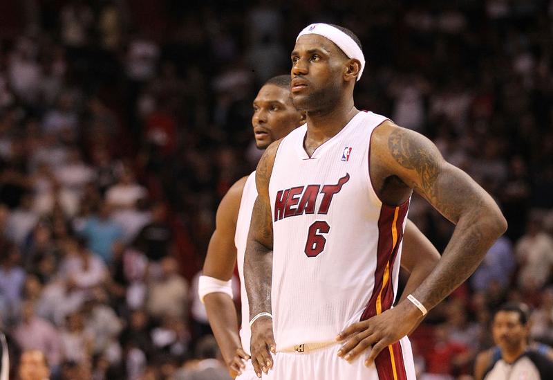 LeBron James #6 and Chris Bosh #1 of the Miami Heat look on during a game against the Washington Wizards at American Airlines Arena on November 29, 2010 in Miami, Florida.