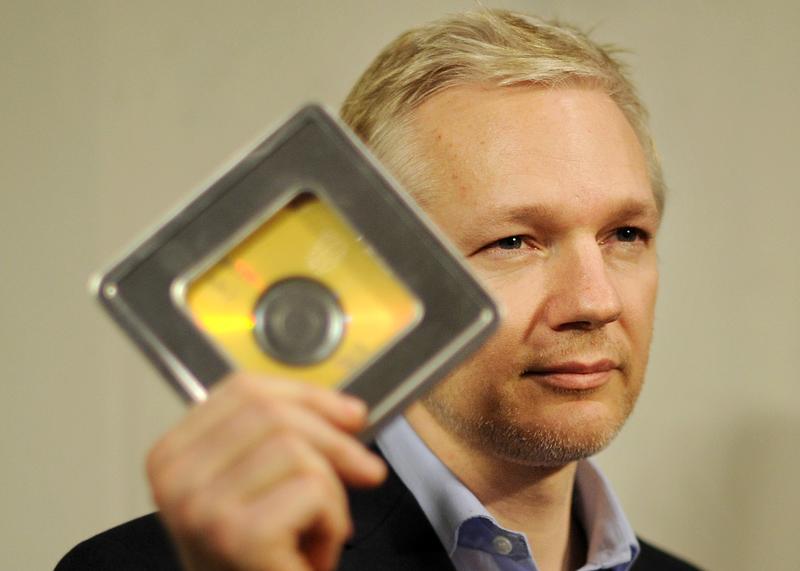 Julian Assange holds a CD containing data given to him by former Swiss banker Rudolf Elmer, following a press conference in London, on January 17, 2011.