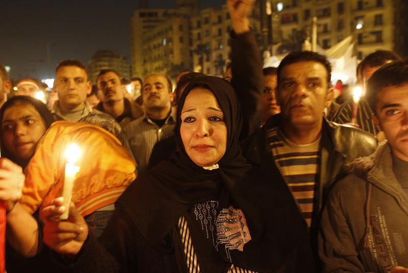 An Egyptian anti-government demonstrator takes part in a candlelight vigil at Cairo's Tahrir Square on February 9, 2011 on the 16th day of consecutive protests calling for the ouster of Mubarak.