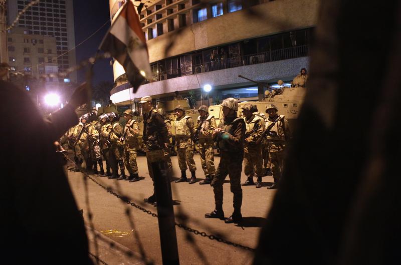 Egyptian army soldiers guard the national television building after Egyptian President Hosni Mubarak's February 10th speech to the nation, in the early hours of February 11, 2011 in Cairo, Egypt.