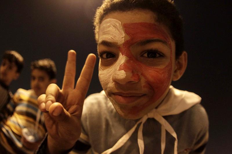 A Bahraini boy with his face painted in the colours of his national flag flashes the victory sign as he takes part in a demonstration calling for a regime change at Pearl Square in Manama, Bahrain.