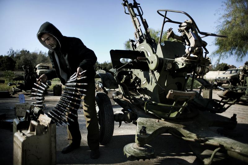 A Libyan civilian holds anti aircraft ammunitions at an army barrack on February 28, 2011 in Benghazi where dozens of civilians registered for a civil defense training amid fears of an air raid.