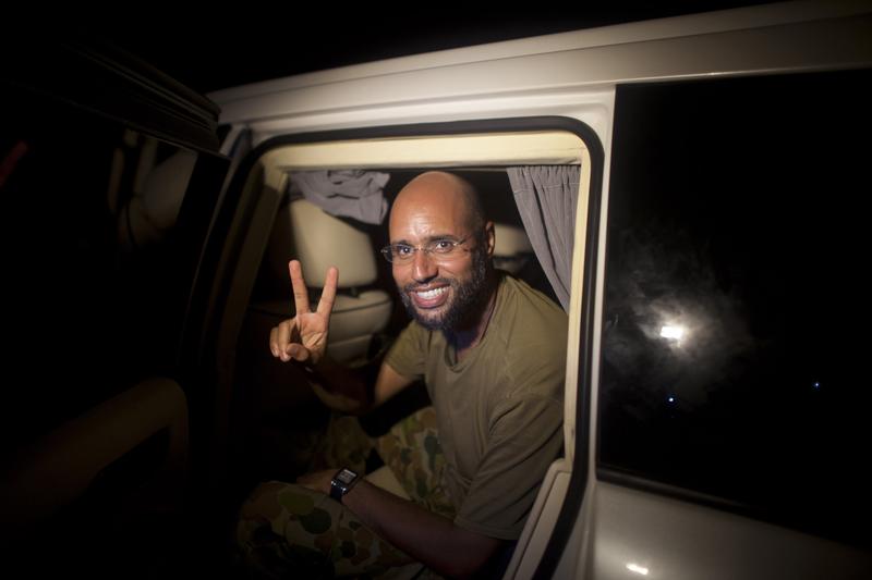 Seif al-Islam Gadhafi, son of Libyan leader Moammar Gadhafi, flashes the V-sign for victory as he appears in front of supporters and journalists in the Libyan capital Tripoli on August 23, 2011.