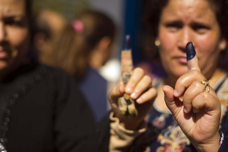 Tunisians women show their inked fingers after voting on October 23, 2011, in a polling station in Ettadhamen, a working class part of Tunis.