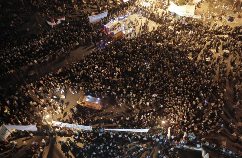 Ambulances make their way through thousands of Egyptian protesters in Tahrir Square in Cairo on November 23, 2011.