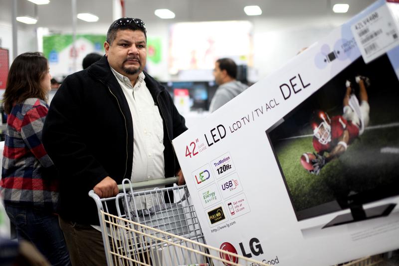 Edgar Hernandez purchases a Television during 'Black Friday' at a Best Buy.