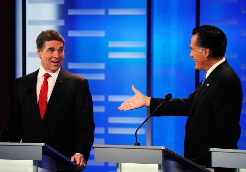 Mitt Romney extends his hand for a $10,000 bet to Texas Gov. Rick Perry.