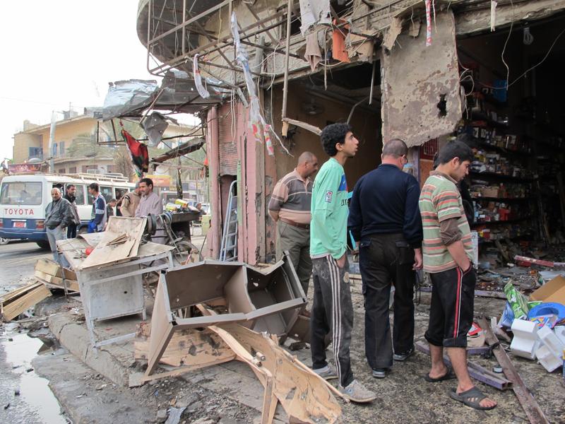 Iraqis inspect the damage after a wave of attacks in Baghdad killed at least 57 people.