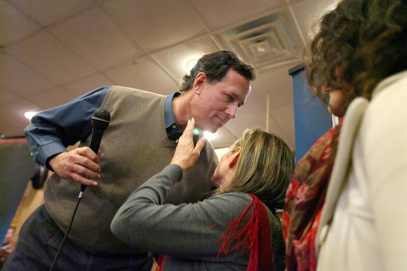 Republican presidential candidate former U.S. Senator Rick Santorum (R-PA) kisses his wife after fielding a question about the death of their son during a campaign rally in Newton, Iowa.