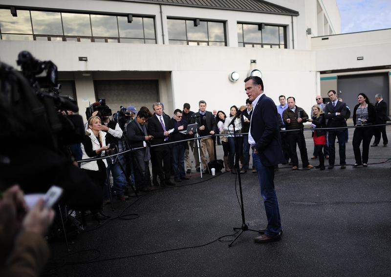 Republican presidential hopeful Mitt Romney talks to journalists after a campaign rally in Florence, South Carolina, January 17, 2012.