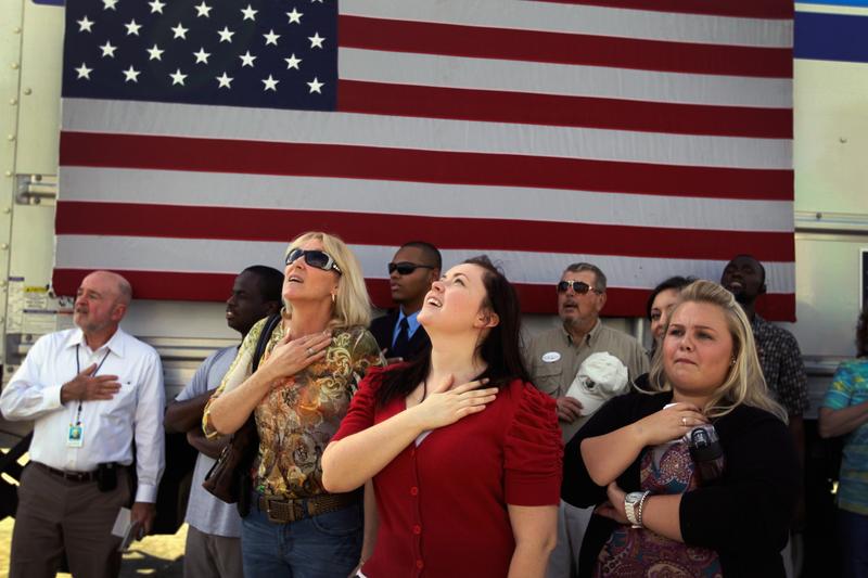 People recite the Pledge of Allegiance before Republican presidential candidate Newt Gingrich speaks during an event at the The River Church on January 23, 2012 in Tampa.