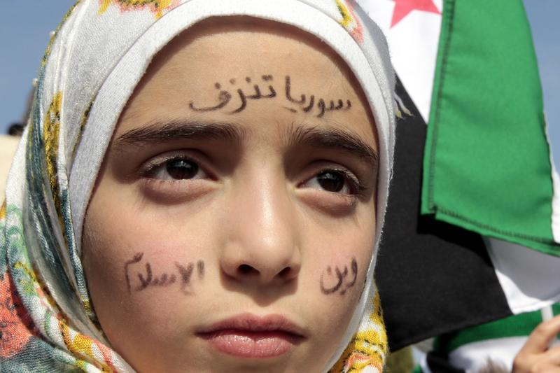 Syrians rally outside the US Embassy in Amman to demand a US military intervention.