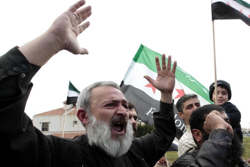 Syrians rally outside the US Embassy in Amman to demand a US military intervention.