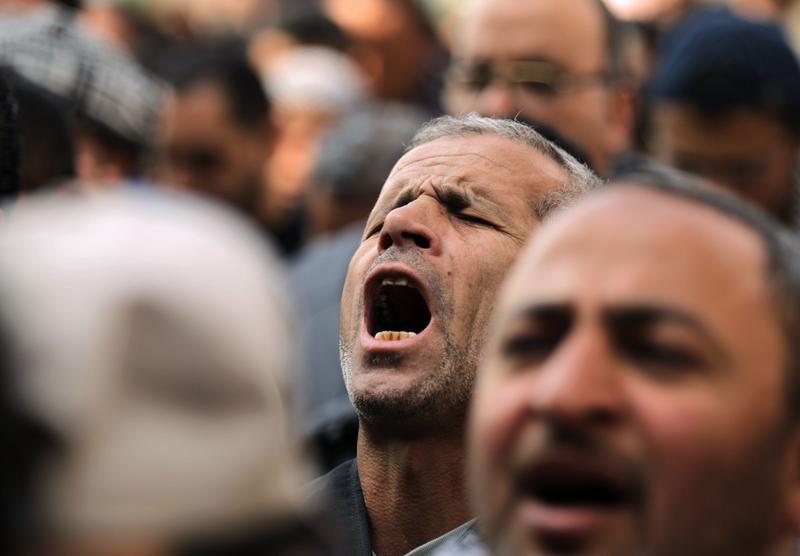 Egyptian anti-goverment demonstrators pray as they carry on with their protest in Cairo's landmark Tahrir Square on February 11, 2011, after the military threw its weight behind President Mubarak