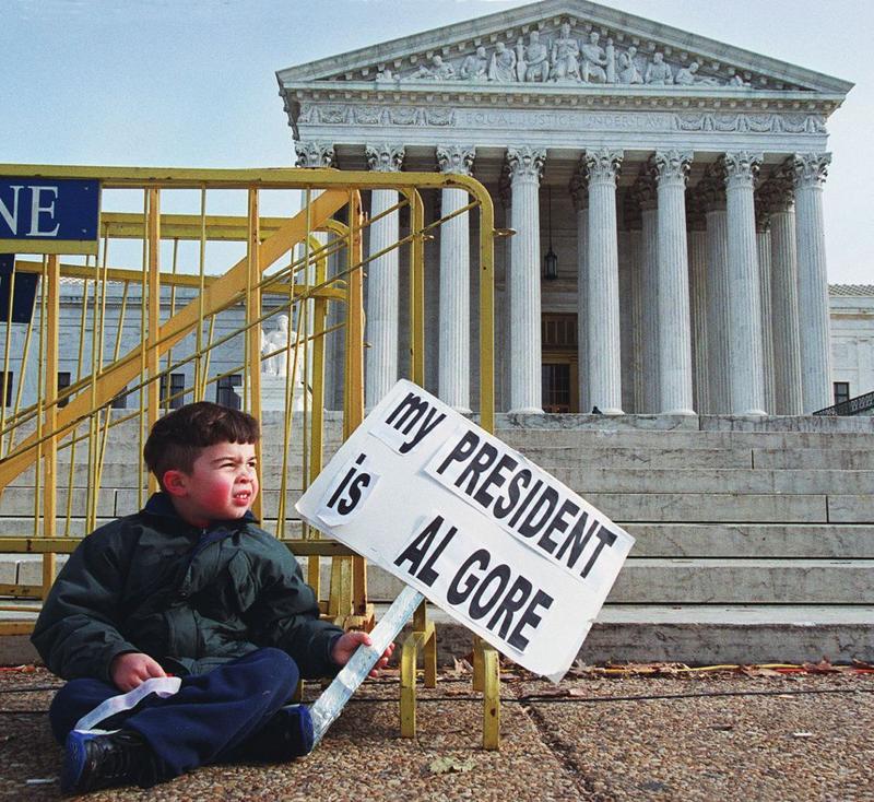 (FILE) Four-year-old Miles Slentz from Aberdeen, Maryland, takes a rest and watches his two elder sisters and parents protest in front of the US Supreme Court, 13 December 2000.