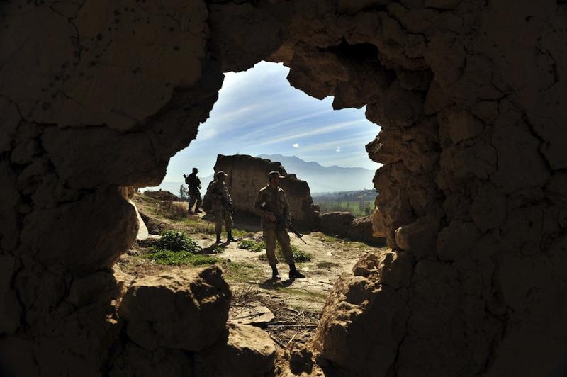 Pakistani soldiers stand guard outside a cave complex, a key militant headquarters in Damadola, in the Bajaur tribal region on March 2, 2010.