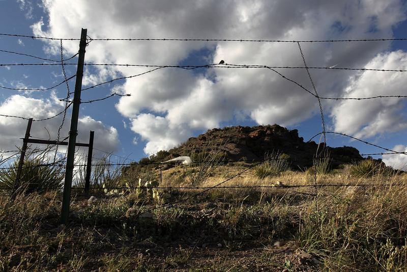 A barbed wire fence guards the U.S.-Mexico border on May 2, 2010 at Montezuma Pass, Arizona.