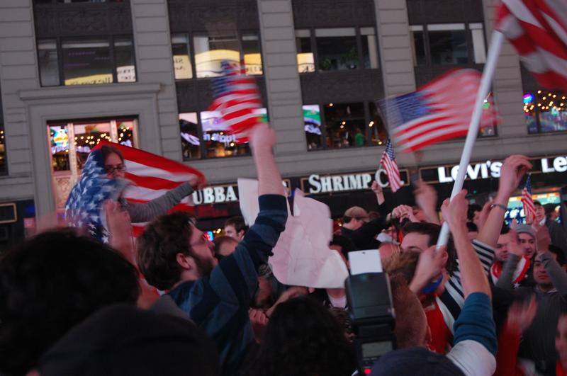 Celebrators cheer and wave American flags in Times Square at the news of Osama Bin Laden's death.